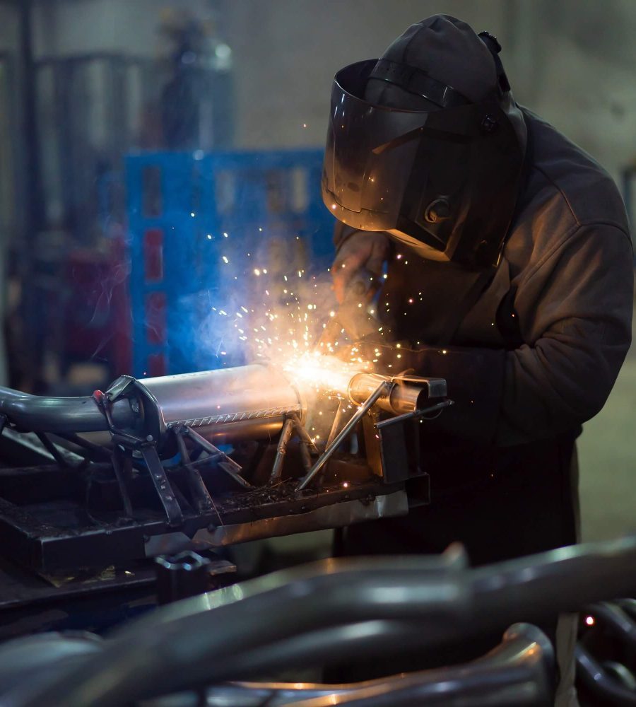 worker-welding-exhaust-pipes-pieces-together-1-pbg6jeynkjgm09gbg8d947lcunhnyvlfddcn6l6fbk